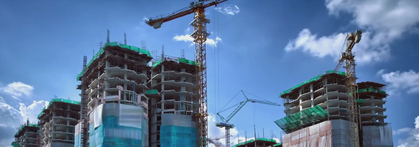 Building under construction with scaffolding and workers.